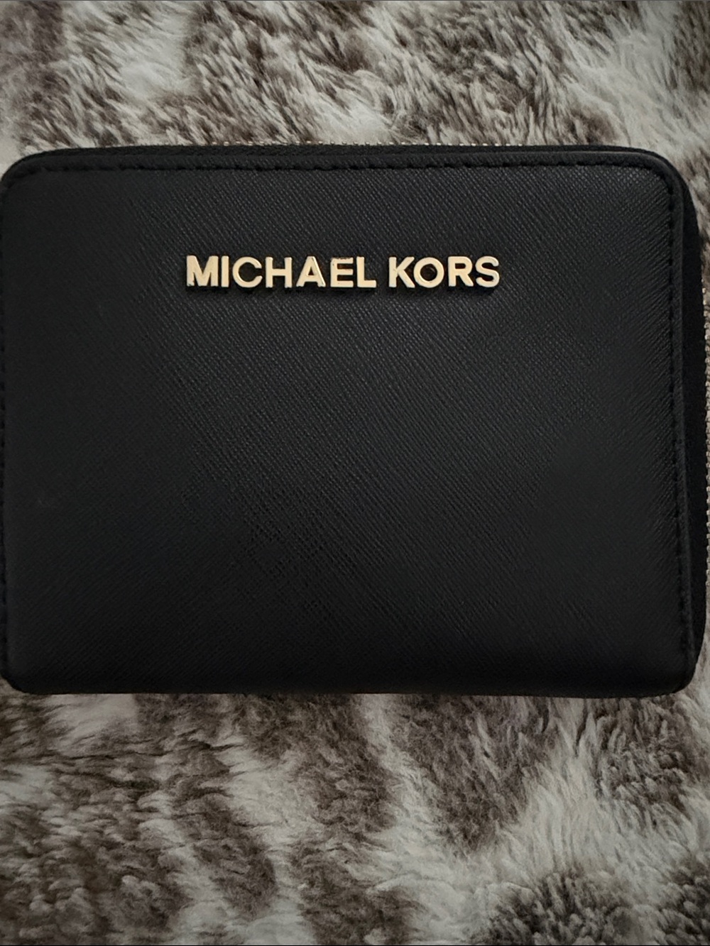 Michael Kors Women’s Black Wallet with Gold Logo Accent.